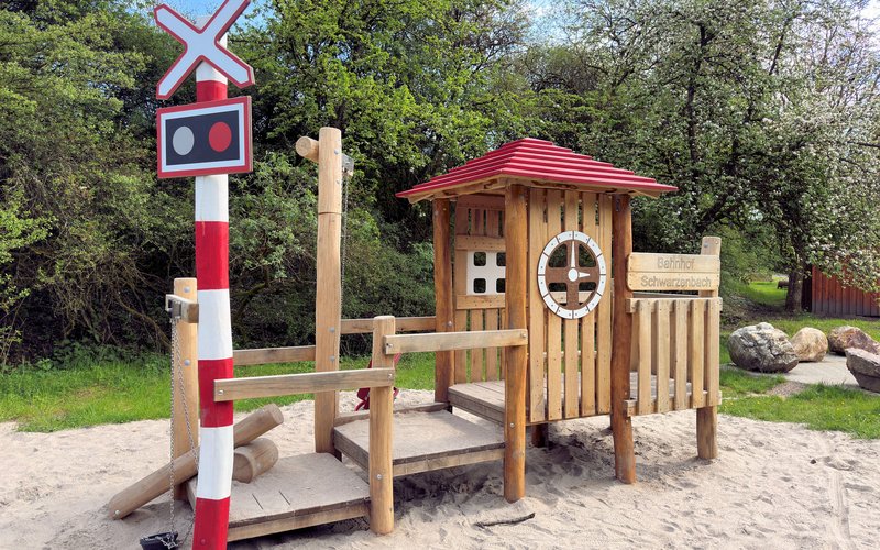 Spielgerät (Nachbildung eines Bahnhofs aus Holz) am Bahnradweg in der Nähe des ehemaligen Bahnhofs Schwarzerden